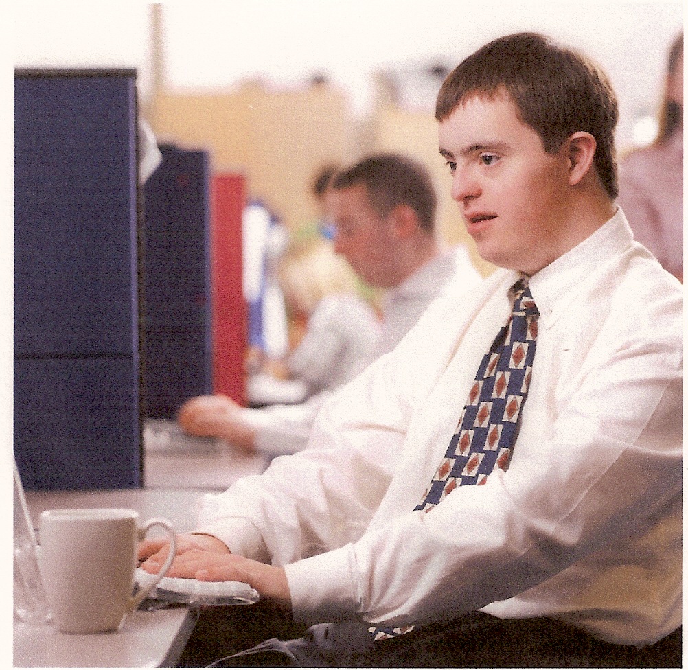 Young man wearing a tie and working on the computer in an office